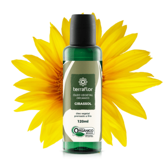 Frasco do óleo vegetal de girassol orgânico 120ml com flor de girassol ao fundo.